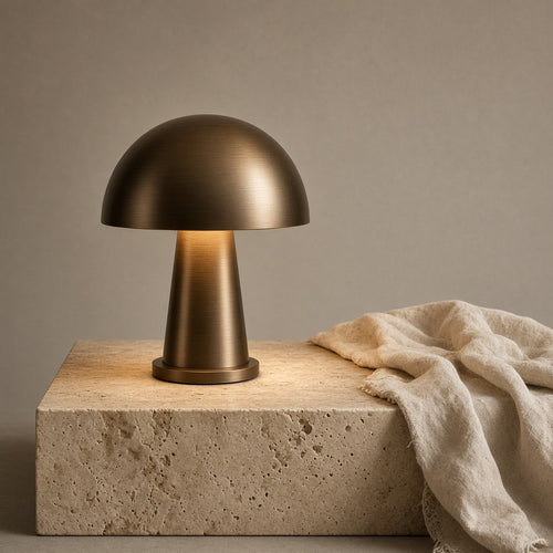 Aetheris Atelier Cordless Anodized-Bronze Mushroom Dome Architectural Nightstand Lamp with downward glare-free reflection on travertine