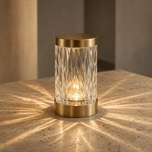 Aetheris Atelier Crystal-Prism Refracting Cordless Architectural Table Lantern projecting geometric caustic light patterns on travertine