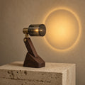 Aetheris Atelier Solid Walnut and Smoked-Glass Optical Sunset Halo Projection Lamp casting warm golden horizon circle on plaster wall